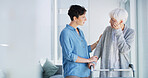 Senior woman, caregiver and walker with talk, guide and support for care, listen and recovery in home. People, helping hand and elderly person with disability, rehabilitation or balance in retirement