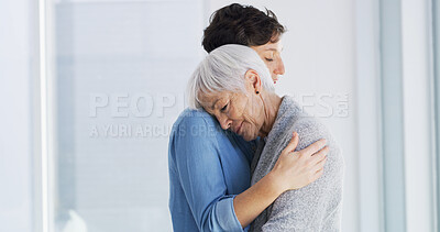 Buy stock photo Emotional, comfort and woman hugging senior mother in retirement home for grief, support or loss. Sad, love and female person embracing elderly mom for empathy, care and emotions in nursing facility.