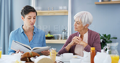 Buy stock photo Senior woman, caregiver and book at breakfast, listen or bonding with food, retirement or help in home. People, connection and literature in morning with care, storytelling or support at family house