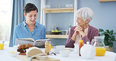 Buy stock photo Woman, senior mother and breakfast with reading book, happy and bonding with food, retirement and help in home. People, connection and literature in morning with care, love or support at family house