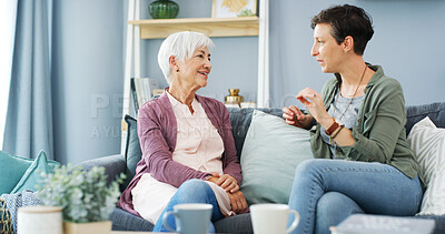 Buy stock photo Conversation, relax and woman with senior mother on sofa with bonding, connection and family. Happy, talking and female person with elderly mom in living room at retirement home for catch up together