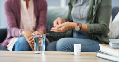 Buy stock photo Hands, glass and pills with caregiver in home for patient, health and medicine with schedule in living room. People, water and drugs for wellness, supplements and benefits in lounge at apartment