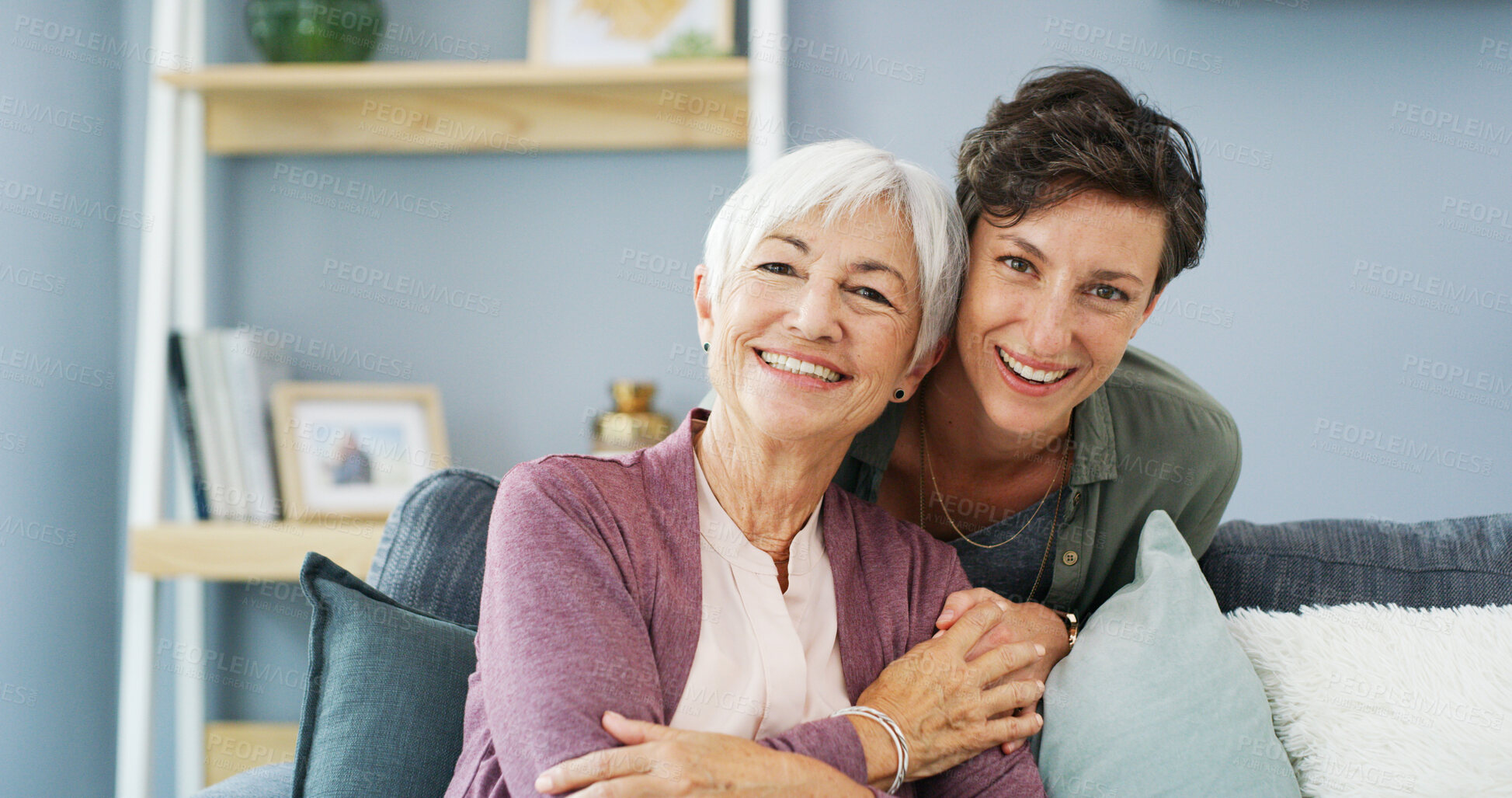 Buy stock photo Hugging, portrait and woman with senior mother for care with bonding, connection and family time. Happy, sofa and female person embrace elderly mom with smile in living room at retirement home.