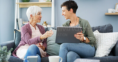 Buy stock photo Tablet, learning and woman with senior mother on sofa for chatting, scrolling or networking. Digital technology, teaching and female person helping elderly mom with online communication in home.