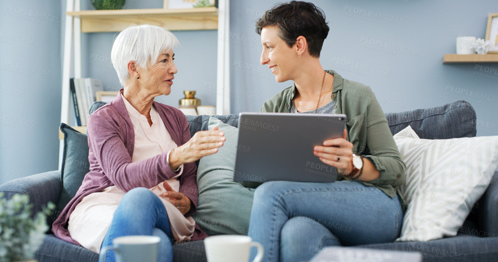 Buy stock photo Tablet, learning and woman with senior mother on sofa for chatting, scrolling or networking. Digital technology, teaching and female person helping elderly mom with online communication in home.