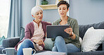 Tablet, teaching and woman with senior mother on sofa for chatting, scrolling or networking. Digital technology, learning and female person helping elderly mom with online communication in home.
