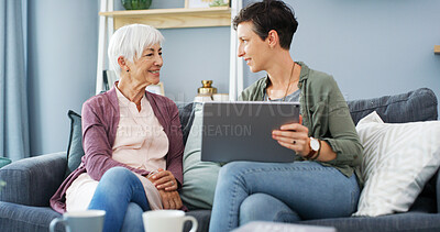 Buy stock photo Tablet, teaching and woman with senior mom on sofa for chatting, scrolling or networking. Digital technology, learning and female person helping elderly mother with online communication in home.