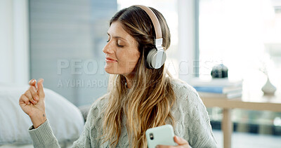 Buy stock photo Dancing, fun and woman with headphones, home and smartphone with playlist on app and living room. House, streaming and person with tech for music, listening and entertainment for girl with mobile