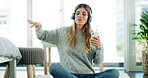 Smartphone, singing and woman with headphones, home and listening to music with app or entertainment. Break, streaming and person with tech for radio, sound and mobile with playlist for girl in house
