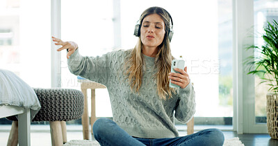 Buy stock photo Smartphone, singing and woman with headphones, home and listening to music with app or entertainment. Break, streaming and person with tech for radio, sound and mobile with playlist for girl in house