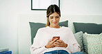 Woman, texting and happy with phone on sofa, chat and check notification in living room at in home. Person, smile and scroll with smartphone, mobile app and contact on social network at apartment
