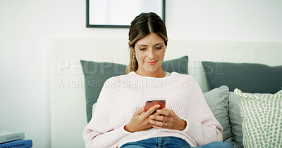 Buy stock photo Woman, texting and happy with phone on sofa, chat and check notification in living room at in home. Person, smile and scroll with smartphone, mobile app and contact on social network at apartment