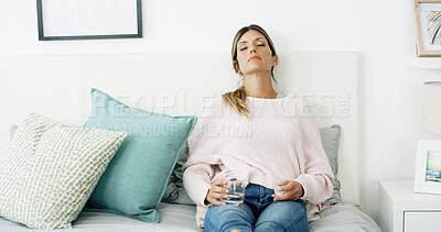 Buy stock photo Sick woman, relax and sofa with water or medication for side effects, symptoms or rest at home. Tired, female person and sleeping with drink, pills or drugs for prescription, cure or chronic illness