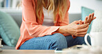 Person, hands or sofa with pain for arthritis, carpal tunnel syndrome or joint inflammation at home. Closeup, patient or fingers with stiffness, swelling or tender skin condition for chronic illness