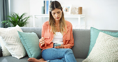 Buy stock photo App, phone and relax with woman on sofa in living room of home for text message. Communication, contact and social media with serious person in apartment for break, online shopping or reading