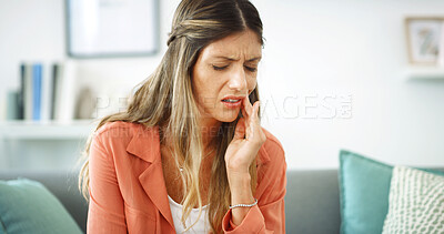 Buy stock photo Woman, relax and pain from toothache at house with cavity, dental problem and gum infection. Female person, discomfort and touch cheek for sore gingivitis, root canal injury and tooth decay in lounge