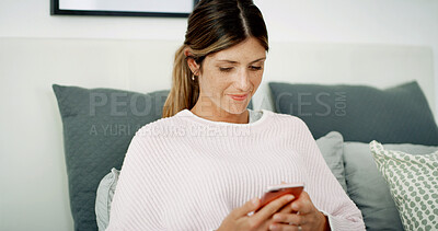 Buy stock photo Woman, phone and smile with texting on sofa, chat and check notification in living room at in home. Person, happy and scroll with smartphone, mobile app and contact on social network at apartment