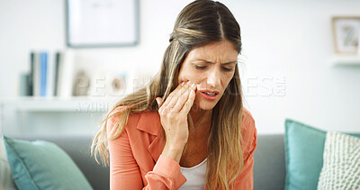 Buy stock photo Woman, touch and cheek with toothache at house with cavity, dental problem and gum infection. Female person, discomfort and pain with gingivitis risk, root canal injury and tooth decay in living room
