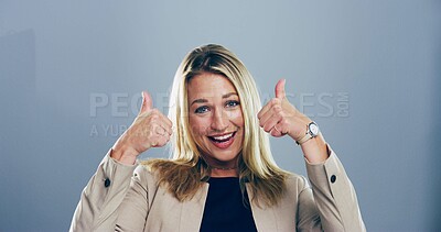Buy stock photo Portrait, thumbs up and woman with feedback, agreement and confidence on gray studio background. Face, person and model with hand gesture, review or icon with symbol, perfect and like with emoji