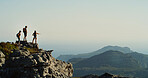 Hiking, group and friends on mountain, pointing and scenery in nature, space and adventure for tourists. Travel, outdoor and people on holiday for exploring, view and back of traveller in environment