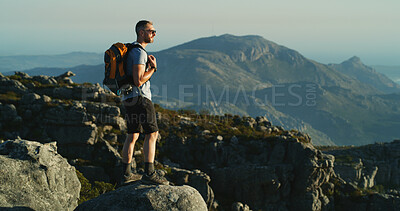 Buy stock photo Hiking, travel and walking with man on mountain for fitness, adventure and blue sky. Wellness, nature and thinking with person and outdoor view on cliff for trekking holiday, explore and mountains