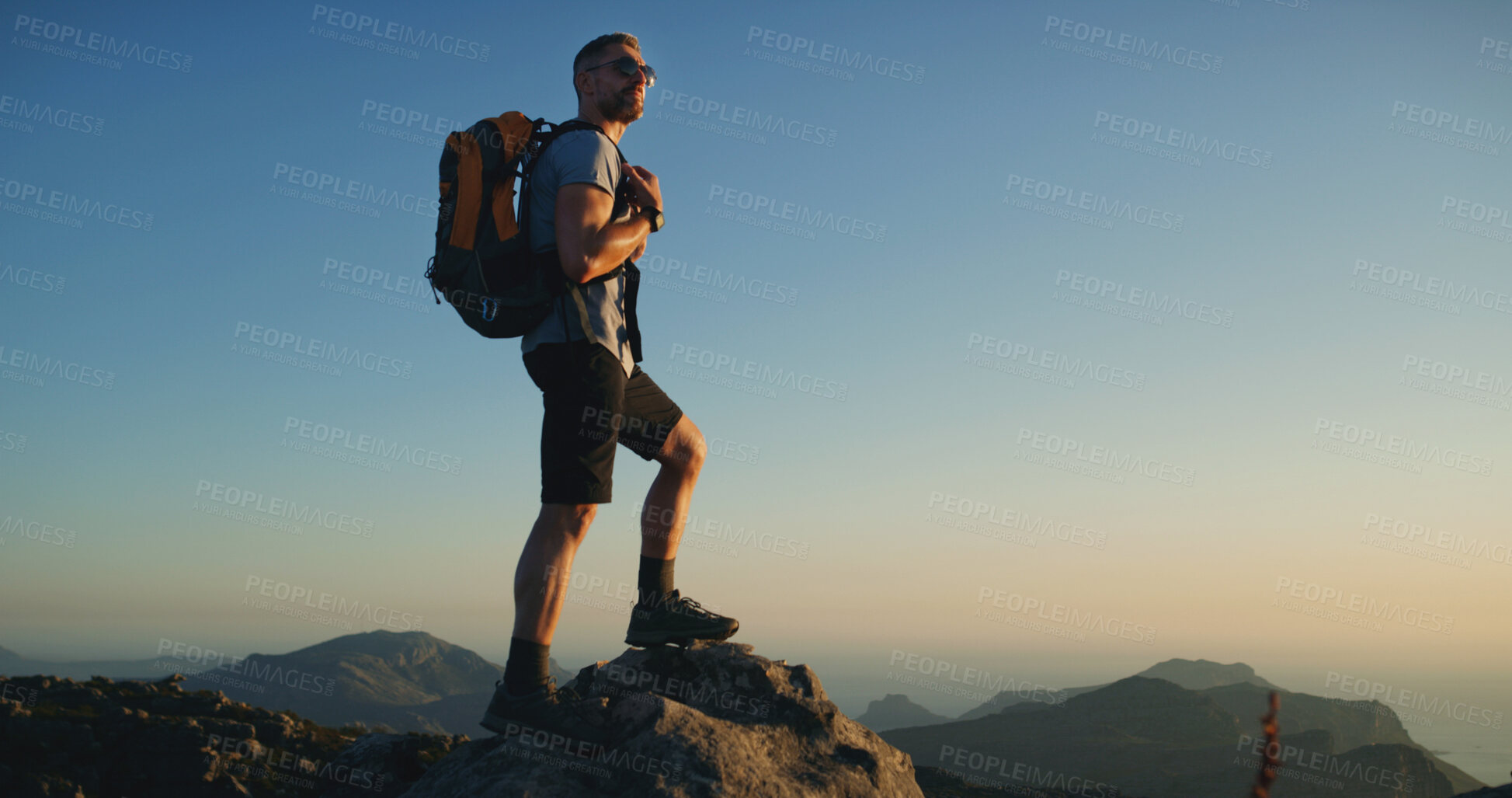 Buy stock photo Hiking, travel and space with man on mountain for fitness, adventure and sky mockup. Health, nature and sunset with person and outdoor view on cliff for trekking holiday, explore and mountains
