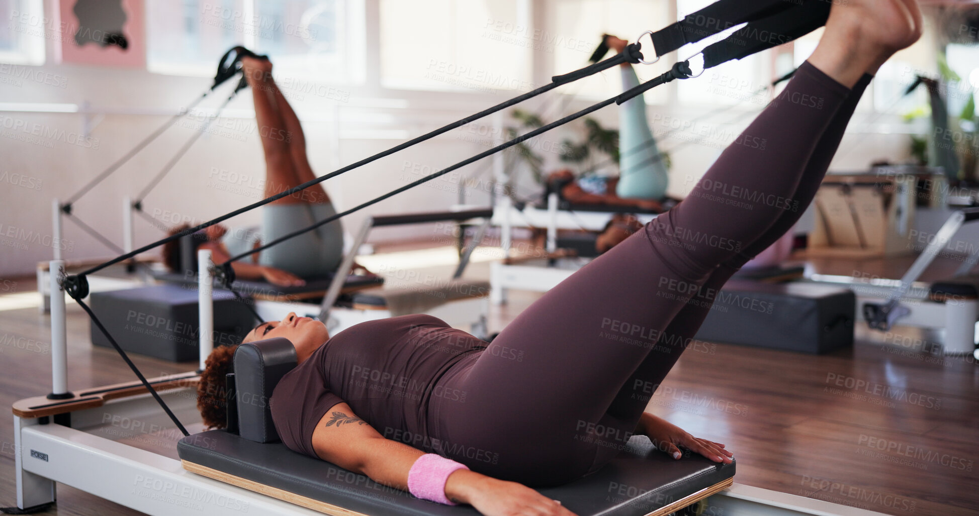 Buy stock photo Pilates, exercise and women with machine in class with reformer for training, workout and mobility. Fitness, gym and people with equipment for stretching legs for wellness, health and challenge