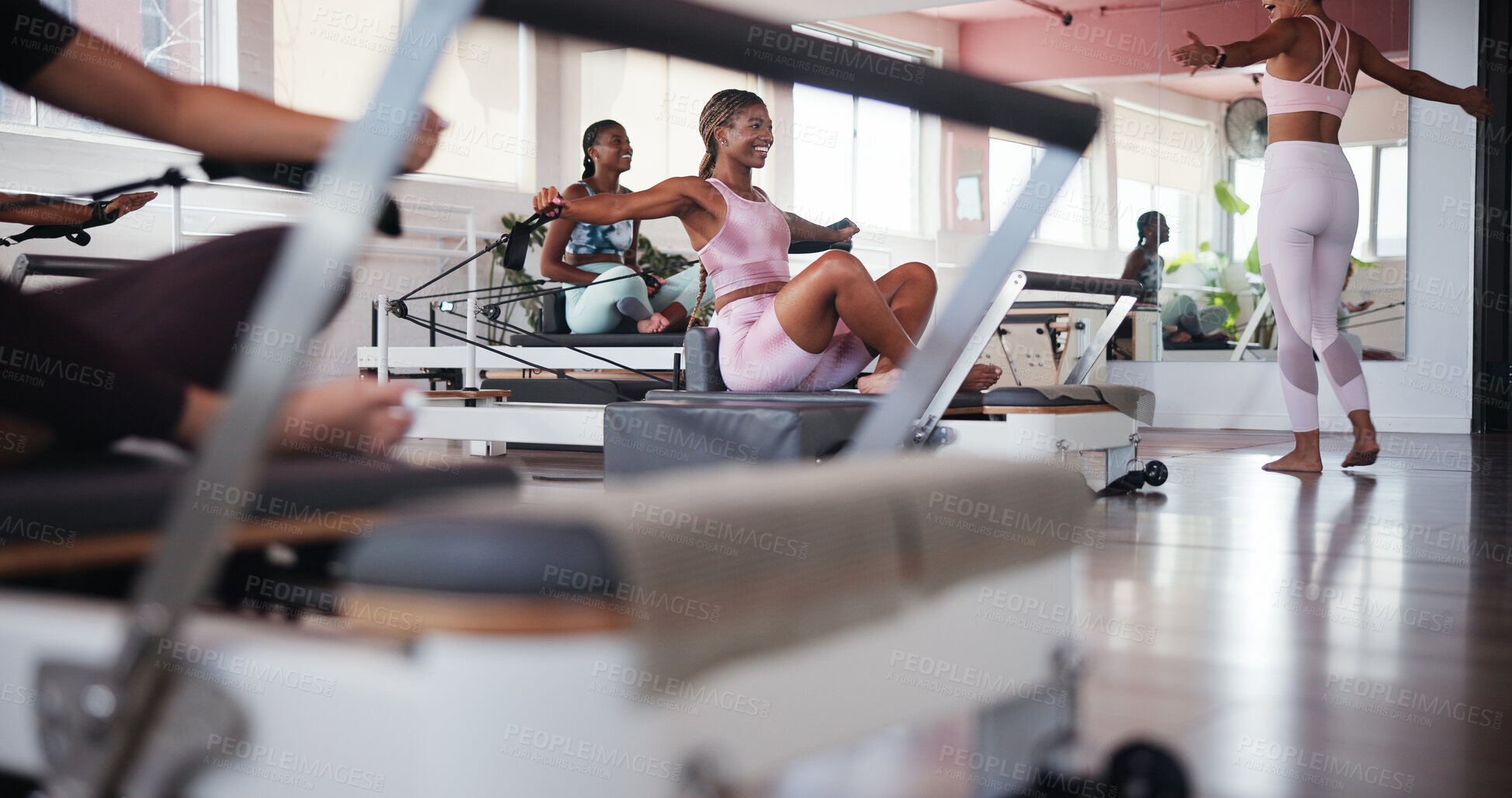 Buy stock photo Fitness, pilates and reformer with women in class for improvement, training or workout routine. Equipment, exercise and smile with happy people on machine in studio for challenge or performance