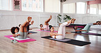 Yoga class, group and wellness with women for boat pose, core strength and endurance with balance. Studio, people and instructor with stretching arms for fitness, pilates and self care with exercise