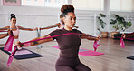 Pilates, exercise and women with resistance band in class for training, workout and mobility. Fitness, gym and people with equipment for stretching arms for wellness, health or challenge for strength