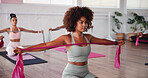 Fitness, pilates and resistance band with woman in studio for improvement, training or workout. Concentration, exercise and strength with people in gym class for challenge or performance routine