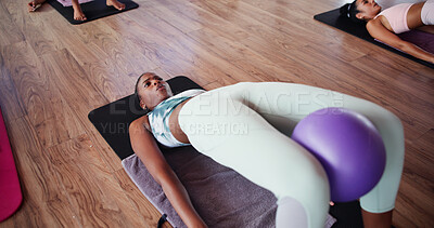 Buy stock photo Workout, pilates and woman with ball in class for exercise, fitness and training in yoga studio. Stretching, gym and people with equipment for health, wellness and challenge for muscle strength