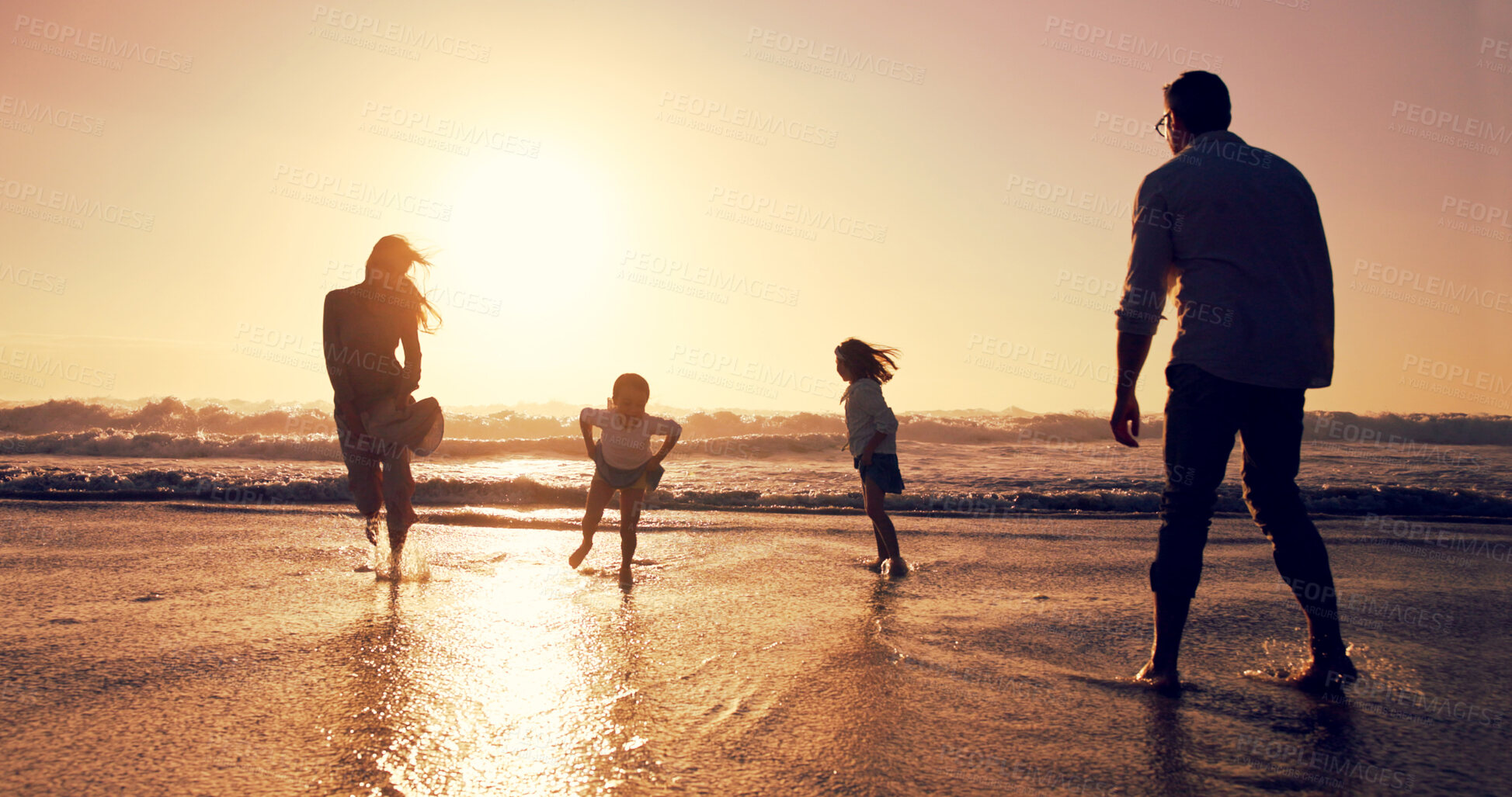 Buy stock photo Sunset, family and play in ocean water for vacation, bonding or energy outdoor. Holiday, mother and father with kids at beach with space for travel, running and game with parents on summer adventure