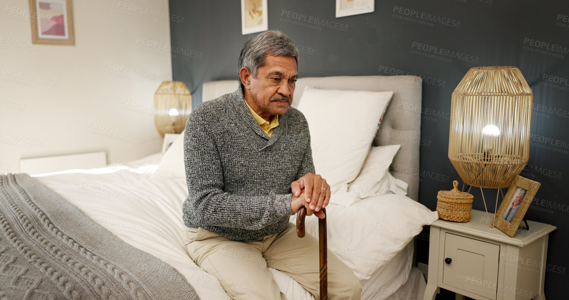 Buy stock photo Senior man, walking stick and thinking in bedroom, memory and reflection in home with nostalgia. Elderly person with disability, cane and perspective with insight, rehabilitation and injury at house