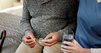 Pills, hands and nurse with senior man in home for medication, supplements or vitamins for wellness. Health, water and caregiver with elderly patient for tablets with treatment in nursing facility.