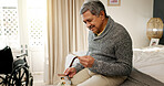 Home, bedroom and old man with pictures, nostalgia and happy with memory, relax and wonder. Pensioner, apartment and mature person with retirement, thinking and remember partner with healing