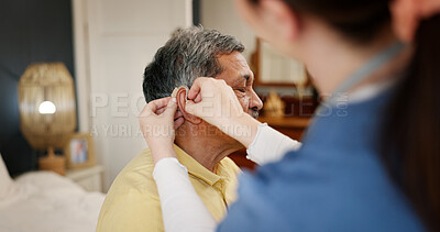 Buy stock photo Nurse, senior man and hearing aid with support, innovation and healthcare for retirement. Patient with disability, caregiver and pensioner with nursing home, rehabilitation and medical implant