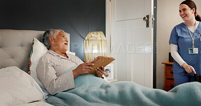 Buy stock photo Talking, senior woman and caregiver in bed, bonding or care for elderly patient with Alzheimer. Healthcare, recovery and old person with tablet in nursing home, rehabilitation or happy with nurse