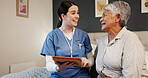 Tablet, conversation and nurse with senior woman in bedroom for medical checkup. Happy, bonding and healthcare worker with elderly female patient on bed with digital technology for treatment plan.