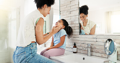 Buy stock photo Mom, girl and help for washing face in bathroom, happy and learning with hygiene, routine and love. African people, mother and daughter with smile, soap and moisturizer for facial skin in family home