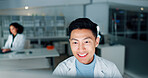 Laboratory, scientist and man with computer for reading, medical research and happiness at night. Career, asian person and doctor with digital for pharmaceutical review, medicine report and results