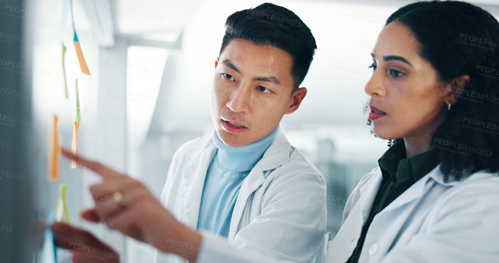 Buy stock photo Lab, scientist and colleagues with medical research, teamwork and people with sticky notes for info. Brainstorming, reading and collaboration for healthcare in clinic, pharmaceutical or plan for cure