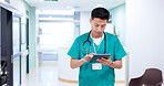 Nurse, tablet and Asian man in hospital for healthcare, report and check records for telehealth. Tech, reading and medical professional on internet for communication, email and scroll research online