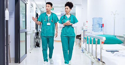 Buy stock photo Surgeon, man and woman with discussion in hallway at hospital with healthcare services for wellness. People, doctors and team with planning for emergency room job, advice or career coaching at clinic