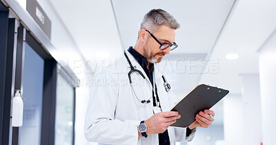 Buy stock photo Doctor, healthcare or man with clipboard at clinic for patient health chart, medical information or schedule. Medicine, mature person or document for insurance paperwork, reading results or checklist