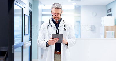 Buy stock photo Hospital, man and doctor with tablet for reading, patient information and medical research. Healthcare, mature person and surgeon with digital for diagnosis results, review and report for treatment