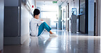 Stress, woman and doctor in hallway, thinking or sad with depression, burnout or challenge. Person, medical or professional in lobby, mistake or pressure with failure in emergency service or bad news