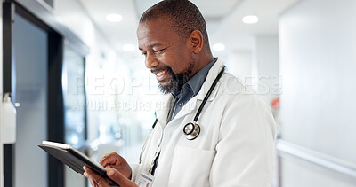 Buy stock photo Hospital, doctor and black man on tablet for online consulting, medical service and diagnosis. Healthcare, clinic and person in hallway on digital tech for planning schedule, appointment or insurance