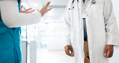 Buy stock photo Hands, healthcare and doctors in hallway, conversation and feedback for intern. Gossip, medical service and people in hospital, performance review and closeup with discussion, diagnosis or advice
