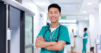 Buy stock photo Happy, man and portrait of nurse in hospital with confidence for healthcare career with crossed arms. Smile, pride and Asian male medical worker in hallway for nursing job with help in clinic.